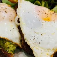 Avocado Toast · Toast is topped with a chipotle aioli and mixed greens with fried eggs
