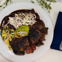 Grilled Skirt Steak · Accompanied with two mole enchilada, and grilled poblano-cream of corn.