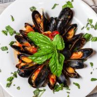 Cozze · Mussels in tomato broth.
