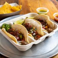 Tacos · A choice of meat, topped with cabbage and/or romaine lettuce, onion cilantro, cheese, salsa ...