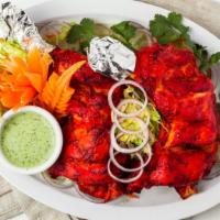 Tandoori Chicken · Chicken leg quarter marinated in spiced yogurt and cooked in traditional clay oven. Served w...