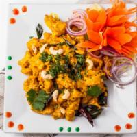 Chicken Cashew Fry · Chicken and cashew nut cooked with special yogurt yellow sauce.
