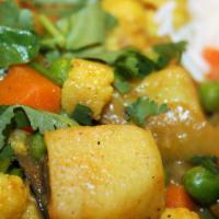 Madras Vegetable Curry · Fresh vegetable cooked with grinded ingredients, curry leaves with native flavor. Served wit...