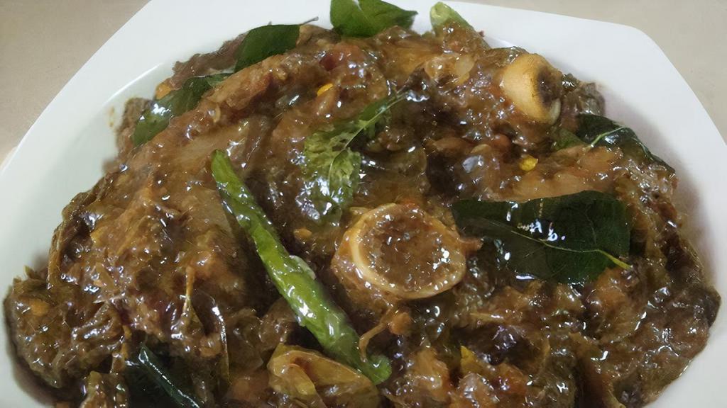 Gongura Goat Curry · Baby goat cooked with fresh gongura and spices. Served with Basmati rice.
