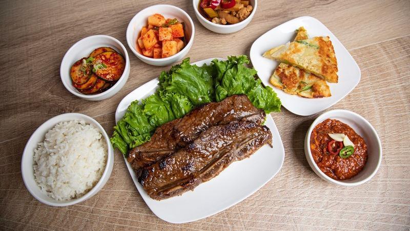A. Galbi Box Set · La galbi (bone in short ribs with house marinade) includes four of chefs seasonal ban Chan (traditional Korean side dishes). comes with White Rice