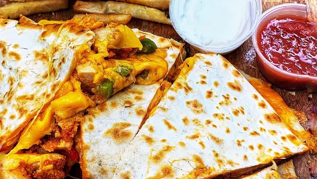 Buffalo Chicken Quesadilla · Breaded chicken basted in our homemade buffalo sauce, sautéed peppers & onions and pepper jack and cheddar cheeses. Served with blue cheese dipping sauce.