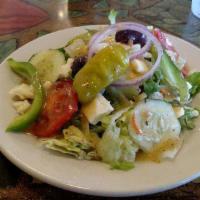 Greek Salad · Romaine, cucumber, tomatoes, Feta Cheese, Black Olives, Red Onions served with your choice o...