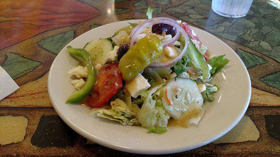 Greek Salad · Romaine, cucumber, tomatoes, Feta Cheese, Black Olives, Red Onions served with your choice of dressing.