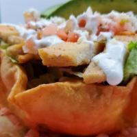 Taco Salad De Carnitas · Crispy flower tortilla beans lettuce onions tomatoes pico de Gallo sour cream Avocado