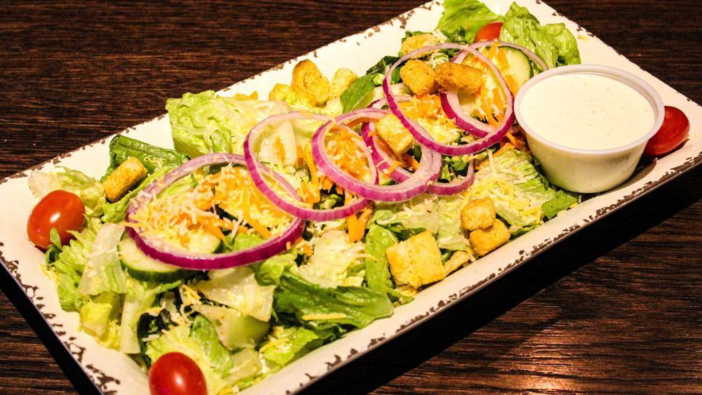 House Salad · Romaine lettuce, tomatoes, cucumbers, red onions, carrot strings, shredded cheese, and croutons.