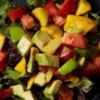 Mango Avocado Salad · Spring mix salad with mango, avocado, cucumbers, tomatoes, and citrus ponzu.