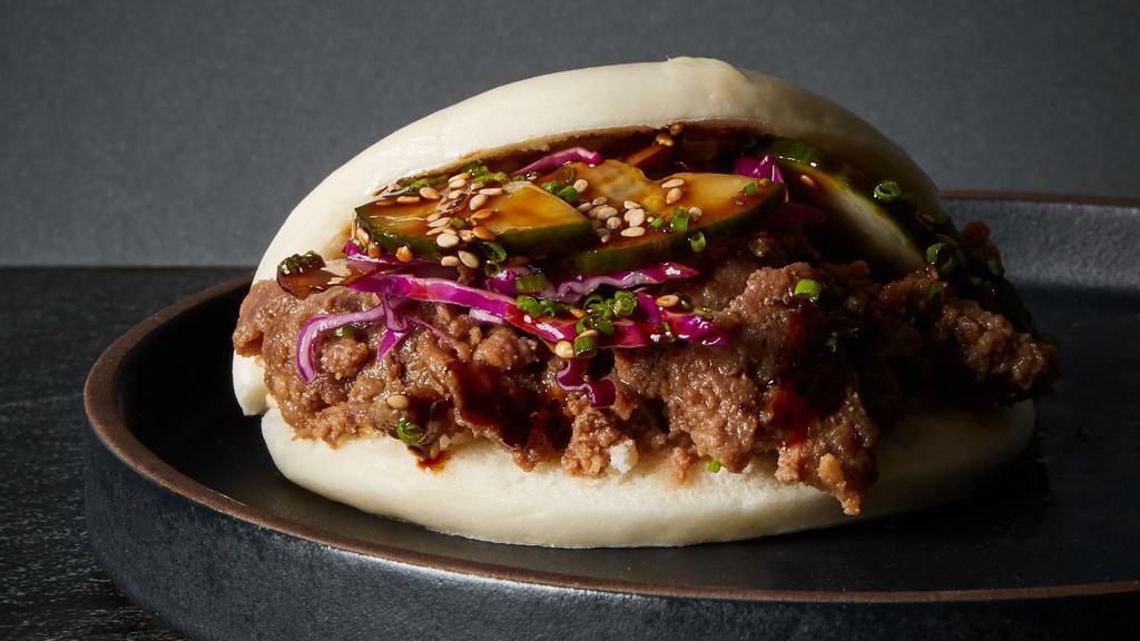 Bulgogi Bao · Thinly sliced korean style beef, cabbage, black sesame seeds, and your choice of sauce
