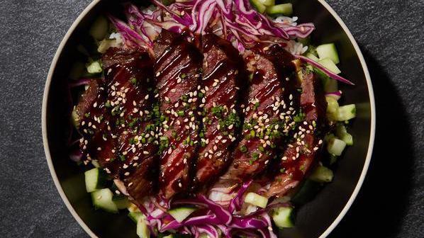 Bulgogi Beef Bowl · Thinly sliced Korean style beef served with cabbage slaw marinated in citrus ponzu, pickled cucumbers, and choice of base