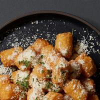 Truffle Parmesan Tots · Tater tots with fresh parmesan cheese and white truffle oil