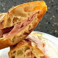The Frenchie · black forest ham, fontina cheese, & cultured salted butter on our classic French baguette