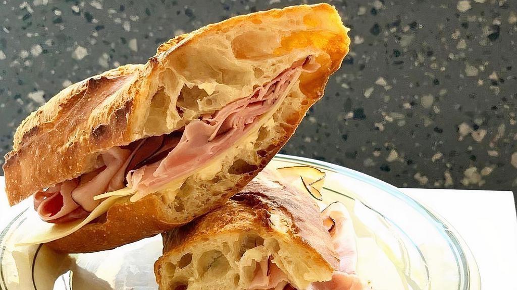 The Frenchie · black forest ham, fontina cheese, & cultured salted butter on our classic French baguette