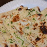 Garlic Naan · Leavened flour bread topped with fresh garlic.