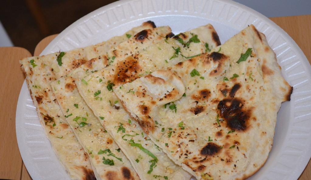 Garlic Naan · Leavened flour bread topped with fresh garlic.