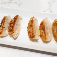 Pan-Fried Pork Gyoza · Infused soy dipping sauce.