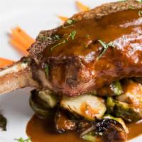 Pork Chop · French cut bone-in chop served with baby carrots, asparagus, and sauce robert.
