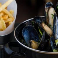 Moules Marinières · Traditional steamed mussels in a white wine, butter, and herb broth. Served with pomme frites.