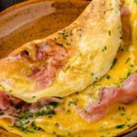 Ham And Egg Omelette Breakfast · Fluffy ham and egg omelette served with toast, home fries, and small tea or coffee.