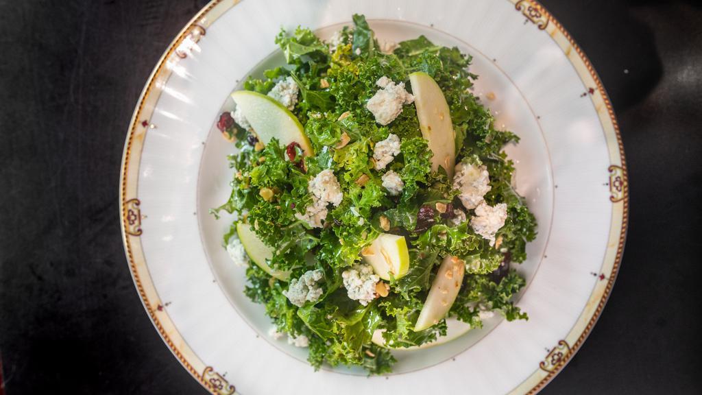 Kale Apple Salad · Honeycrisp Apples, toasted walnuts, granola, dried cranberries, white balsamic vinaigrette, and blue cheese crumbles. Add grilled chicken for an additional price.