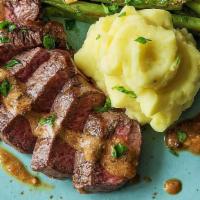 14 Oz Certified Grass-Fed New York Strip · Served with mashed potatoes, market vegetables, and peppercorn sauce.