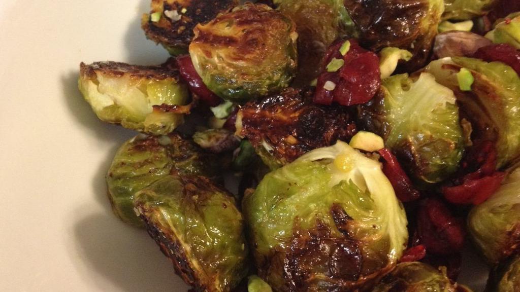 Crispy Brussels Sprouts · Contains nut/nut allergy. Sriracha hint, lemon juice, dried cranberries, pistachios, and honey drizzle.