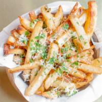 Truffle Fries · Tossed in 5 months aged grated parmesan cheese, parsley, and black truffle oil drizzle.