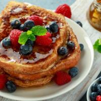Original French Toast · Custard-dipped, thick-cut brioche bread topped with whipped butter and syrup.