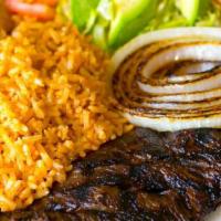 Lunch Tacos De Asada · Two tacos filled with steak then topped with cilantro and onion. Served with rice and beans....