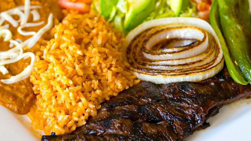 Carne Asada · Skirt steak, guacamole, rice and beans.