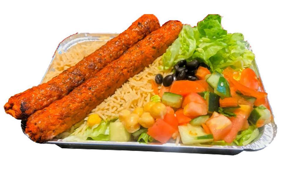 Kofta Kebab Over Rice · Kabab made with ground chicken and herbs served over brown basmati with choice of salad and any of sauces.