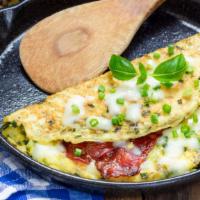 Bacon & Cheese Omelette · Sizzling hot Omelette made with Bacon and cheese. Served with a side of home fries and custo...