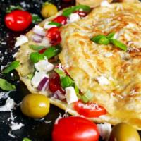 Greek Omelette · Gratifying Greek Omelette made with feta cheese and tomatoes. Served with home fries and toa...