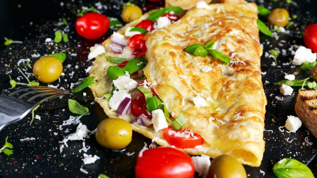 Greek Omelette · Sizzling hot Omelette made with Feta cheese, onion, and tomato. Served with a side of home fries and customer's choice of Toast.