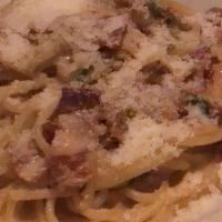 Spaghetti Alla Carbonara · Pasta bathed in a delicious combination of pancetta, prosciutto, onions and parmigiano reggi...