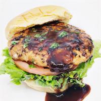 Jerk Salmon Burger · Fresh Salmon Burger with Jerk Seasoning & Sauce. Lettuce, Sliced Tomato and Ramadan Sauce on...