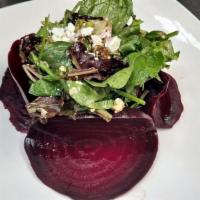 Roasted Beet Salad · Mixed greens, fresh roasted beets, candied walnuts and crumbled goat cheese.