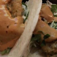 Baja Fish Tacos · Three soft tacos. Cabbage and creme.