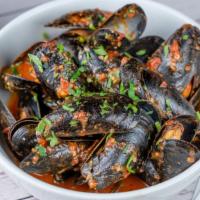 Steamed Mussels With Marinara Sauce · Steamed mussels, champagne butter broth, bruschetta, over crispy French fries.
