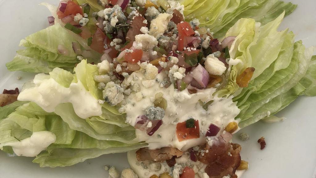 Wedge Salad · Iceberg, roasted corn, crispy applewood bacon, crumbled blue cheese, tomato, blue cheese dressing.