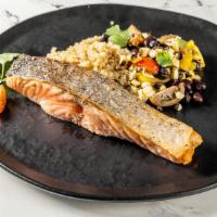 Roasted Salmon · Roasted Salmon served on a quinoa bowl topped with black beans, jalapeño, roasted corn, pick...