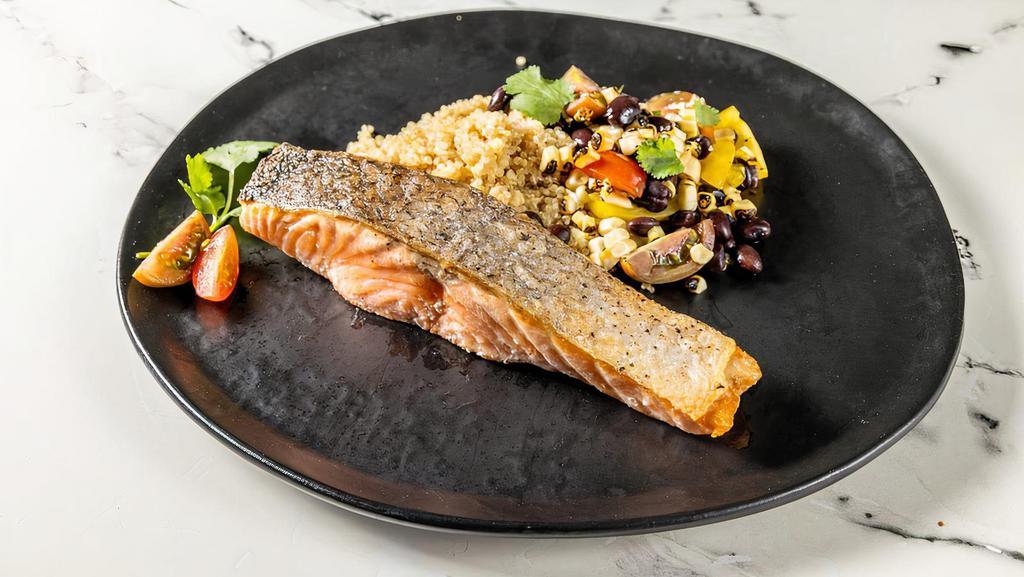 Roasted Salmon · Roasted Salmon served on a quinoa bowl topped with black beans, jalapeño, roasted corn, pickled shallots and cherry tomatoes.