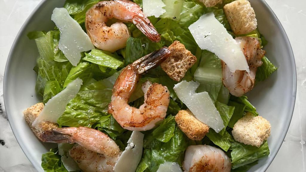 Shrimp Ceasar Salad · Shrimp served on a bed of Romaine lettuce, shaved pecorino romano, herbed croutons, with a side of caesar dressing.