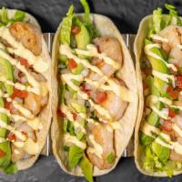 Grilled Shrimp Tacos · Grilled shrimp gets served with lettuce on a corn tortilla with caramelized cheese, salsa ve...