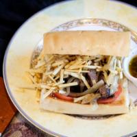 Pan Con Bistec · Grilled sirloin steak or chicken breast, grilled onions, sliced tomato, and shoestring potat...