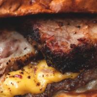 Papa Smokes Burger · 2 USDA beef patties, 18 hour smoked brisket, Cheddar and Havarti cheese, BBQ Sauce, on brioc...