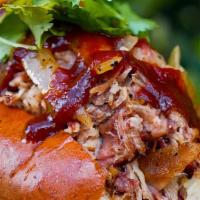 Bbq Pork Roll · Smoked BBQ pork, BBQ sauce, lettuce, onions, pickles, cilantro, on a house baked butter roll...